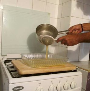 Straining the liquid from the cannabis remains